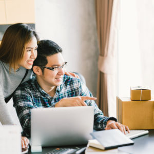 Young Asian couple startup family business, online marketing packaging and delivery scene. SME entrepreneur, business partner, or freelance work at home concept
